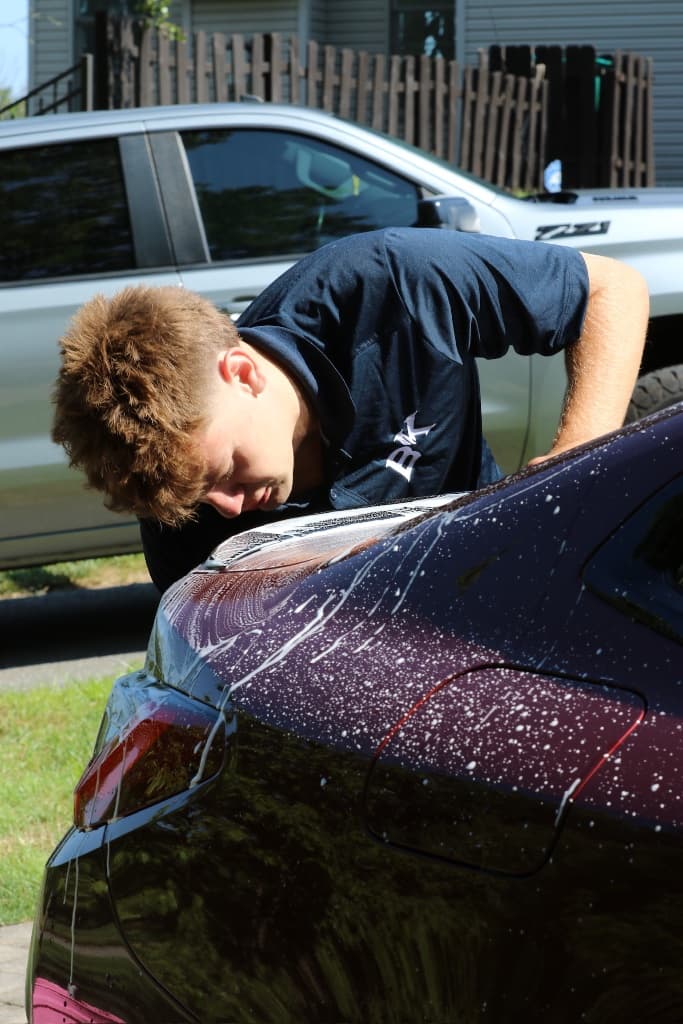 Vehicle exterior covered in foam during pre-coating decontamination